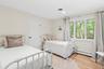 Bedroom featuring baseboard heating and light wood-style floors