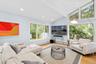 Living room with a baseboard heating unit, light wood-style flooring, and recessed lighting