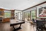 Recreation room with beverage cooler, pool table, a wainscoted wall, ornamental molding, and bar with sink