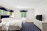 Bedroom with crown molding, dark wood finished floors, and recessed lighting