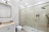 Bathroom with a shower stall and vanity