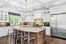 Kitchen featuring glass insert cabinets, stainless steel appliances, tasteful backsplash, dark wood finished floors, and beamed ceiling