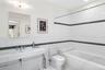Full bathroom with tile walls, recessed lighting, and tiled shower / bath combo