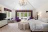 Bedroom with access to outside, carpet floors, a chandelier, french doors, and high vaulted ceiling