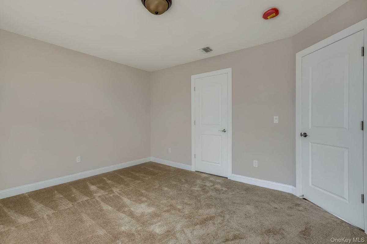 Unfurnished bedroom featuring baseboards, visible vents, and carpet flooring
