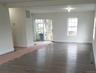 Unfurnished room with wood finished floors, visible vents, and baseboards