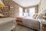 Bedroom with wallpapered walls