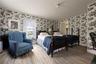 Bedroom with wallpapered walls