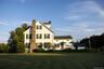 View of front of home featuring a chimney and a front yard