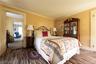 Bedroom featuring dark colored carpet and crown molding