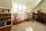 Sitting room featuring a wainscoted wall and wood finished floors