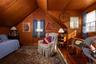 Bedroom featuring wood finished floors, lofted ceiling, wood walls, and wood ceiling
