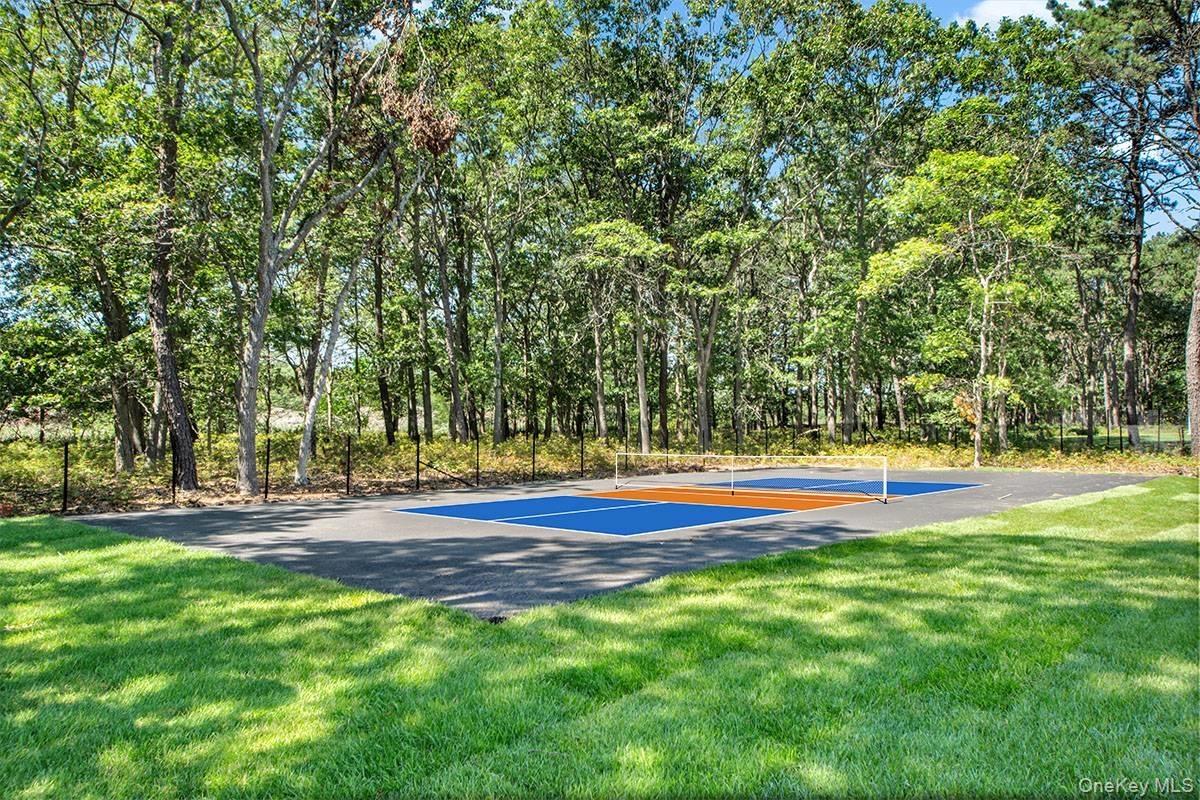 View of pickleball court featuring a lawn