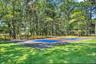 View of pickleball court featuring a lawn