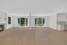 Unfurnished living room featuring healthy amount of natural light, light wood-style flooring, recessed lighting, and a fireplace