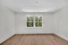 Empty room with light wood-style flooring and recessed lighting