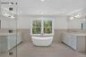 Bathroom with wainscoting, vanity, a freestanding tub, light tile patterned floors, and recessed lighting