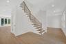 Stairway with recessed lighting and wood finished floors