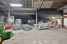 Miscellaneous room with brick floors and a garage