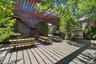 Deck featuring outdoor dining area, a pergola, a patio area, and stairs