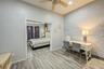 Bedroom featuring a ceiling fan, baseboards, and wood finished floors