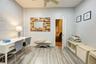 Office space with light wood-type flooring and a ceiling fan