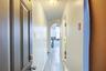 Hall featuring arched walkways and light wood finished floors