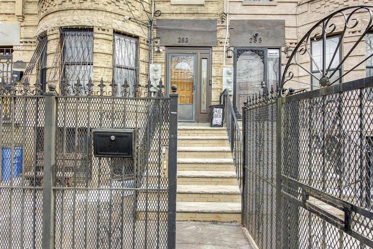 Property entrance with brick siding and fence
