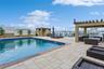 View of pool with a water view, a patio, and an outdoor hangout area