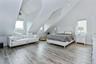 Bedroom featuring vaulted ceiling and light hardwood / wood-style floors