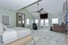 Carpeted bedroom with french doors, high vaulted ceiling, access to outside, and multiple windows
