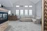 Living room featuring carpet flooring, high vaulted ceiling, and a fireplace