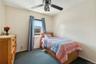 Carpeted bedroom with ceiling fan