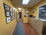 Hall with a paneled ceiling, dark wood finished floors, and baseboards