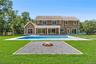 Rear view of property featuring an outdoor pool, a patio, and an outdoor fire pit