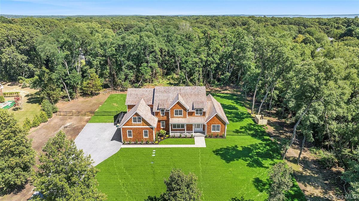 View of subject property with a heavily wooded area