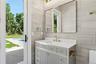 Bathroom with vanity and tile walls