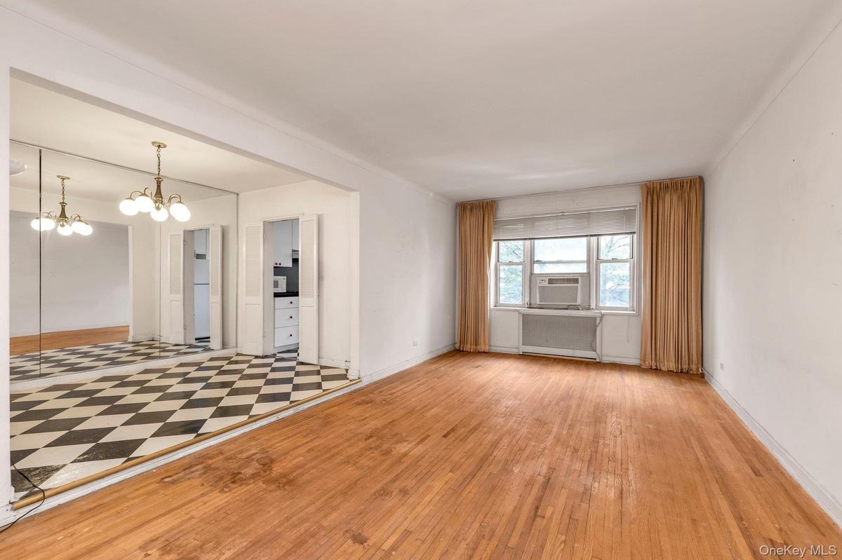 Unfurnished room with a chandelier and light wood-style flooring