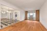 Unfurnished room with a chandelier and light wood-style flooring