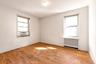 Empty room with radiator heating unit, light wood finished floors, and plenty of natural light