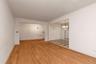 Empty room featuring a chandelier and light wood-style flooring