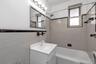 Full bath featuring  shower combination, tile walls, and vanity