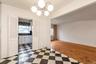 Unfurnished dining area featuring light flooring and a chandelier