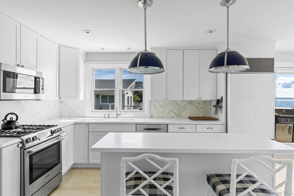 Custom designed kitchen boasting top amenities and additional prep space.