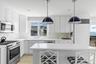 Custom designed kitchen boasting top amenities and additional prep space.