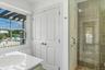 Additional full bathroom conveniently located for guests and access from outdoor shower and beach.