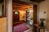 Foyer entrance with a wooden ceiling with exposed beams and arched walkways
