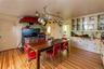 Dining area featuring light wood-style flooring and brick wall