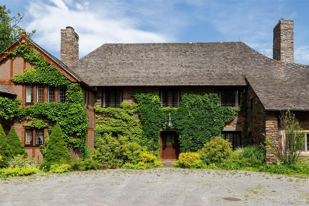 Tudor-style house featuring a chimney