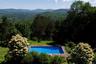 Outdoor pool featuring a mountain view and a wooded view